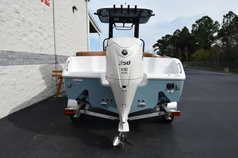 Slide: The Image of 2026 Sea Hunt Ultra 255 SE boat with Yamaha V6 engine, parked outdoors. - 4