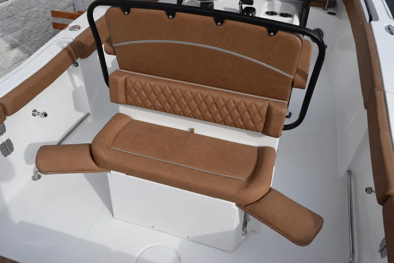 Slide: The Image of 2026 Sea Hunt Ultra 255 SE boat interior with brown cushioned seating. - 7