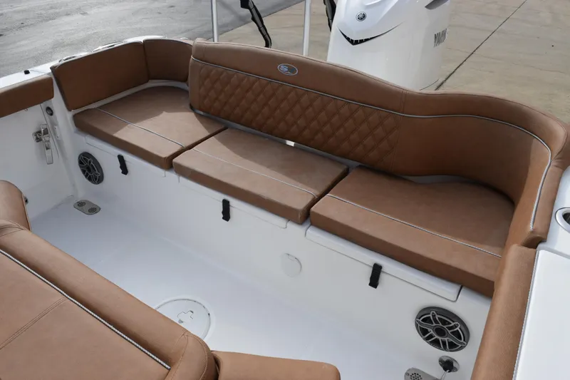 Slide: The Image of Luxurious seating on 2026 Sea Hunt Ultra 255 SE boat, featuring brown cushioned seats. - 8