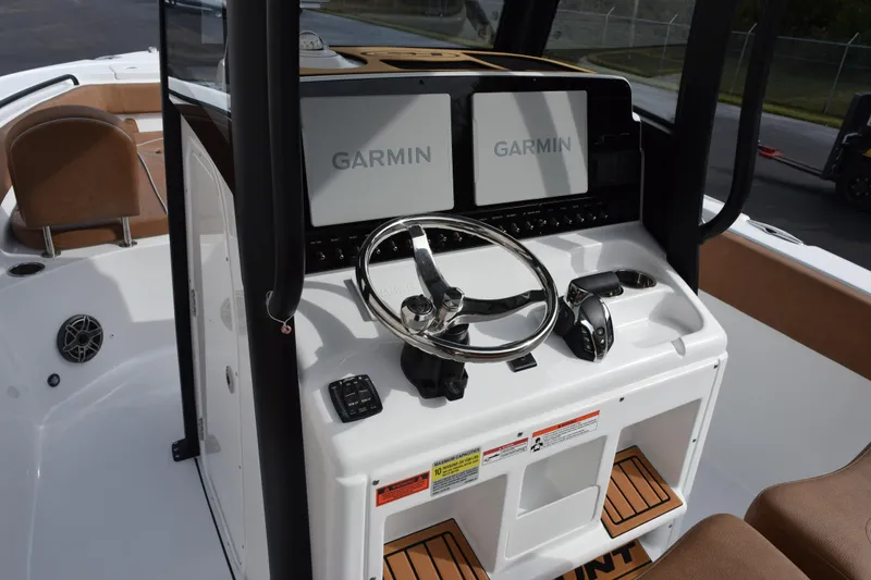 Slide: The Image of 2026 Sea Hunt Ultra 255 SE boat dashboard with Garmin navigation displays. - 9