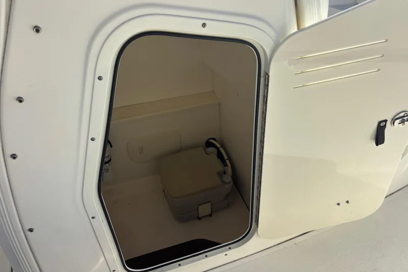 Slide: The Image of 2015 Boston Whaler 270 Dauntless boat storage compartment with open door. - 10