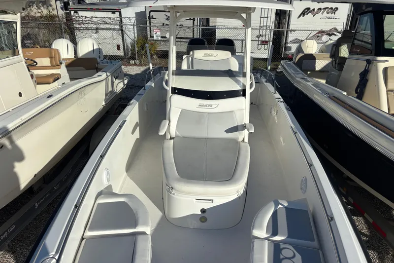 Slide: The Image of 2015 Boston Whaler 270 Dauntless boat, white interior, parked in a marina. - 11