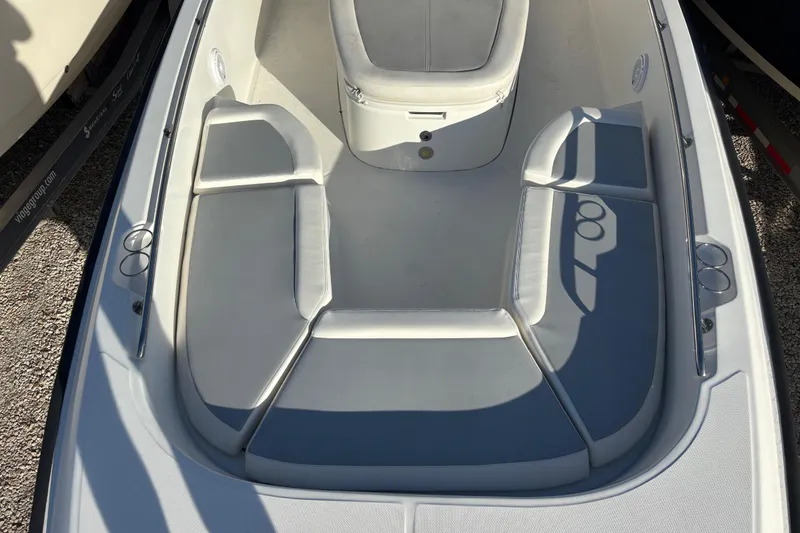Slide: The Image of 2015 Boston Whaler 270 Dauntless boat interior with cushioned seating and cup holders. - 12