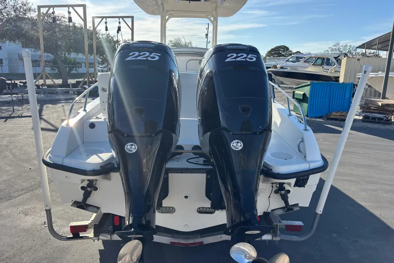 Slide: The Image of 2015 Boston Whaler 270 Dauntless with twin 225 horsepower engines, docked outdoors. - 6