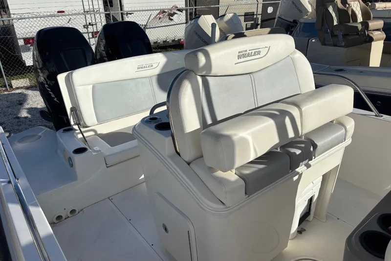 Slide: The Image of 2015 Boston Whaler 270 Dauntless boat interior with seating and dual engines. - 8