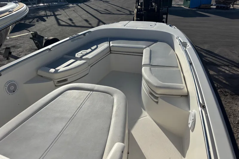 Slide: The Image of 2015 Boston Whaler 270 Dauntless boat interior with cushioned seating and clean deck. - 9