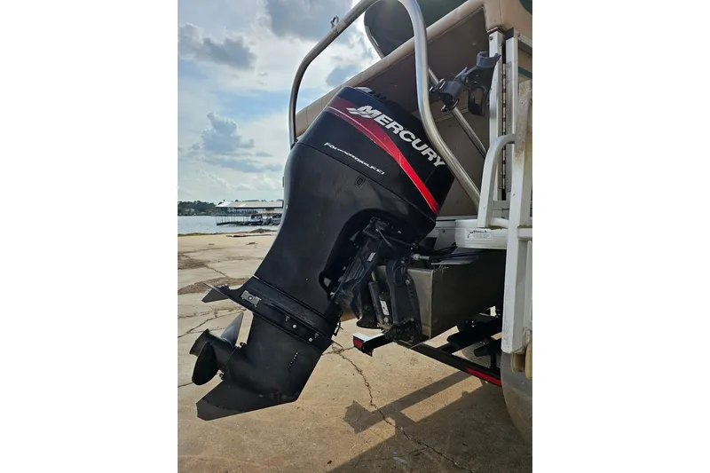 Slide: The Image of 2004 Parti Kraft Admiral 240 RE with Mercury outboard motor at dockside. - 11