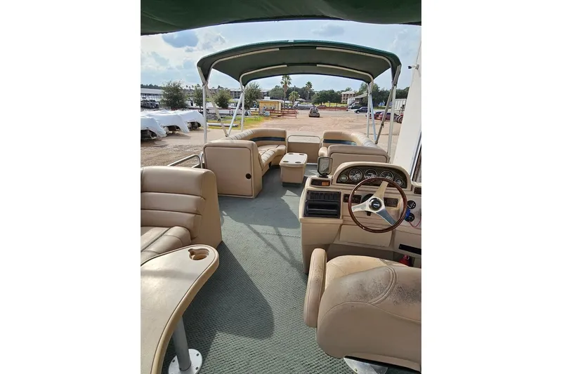 Slide: The Image of Interior of 2004 Parti Kraft Admiral 240 RE pontoon boat with beige seating and steering console. - 4