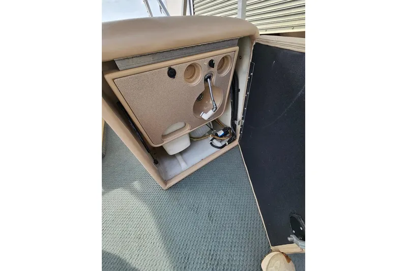 Slide: The Image of 2004 Parti Kraft Admiral 240 RE boat interior storage compartment with cup holders and faucet. - 7