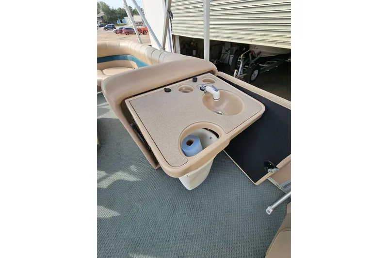 Slide: The Image of 2004 Parti Kraft Admiral 240 RE boat interior with sink and seating area. - 8