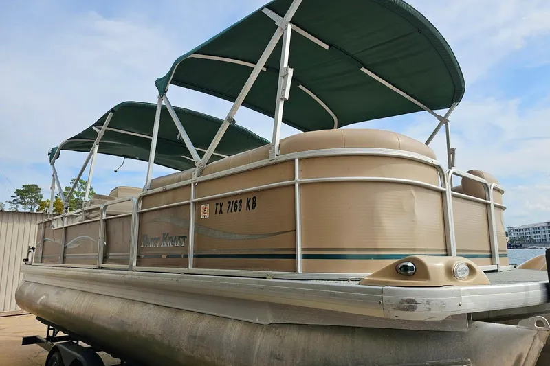 Slide: The Image of 2004 Parti Kraft Admiral 240 RE pontoon boat with green canopy and beige exterior. - 9