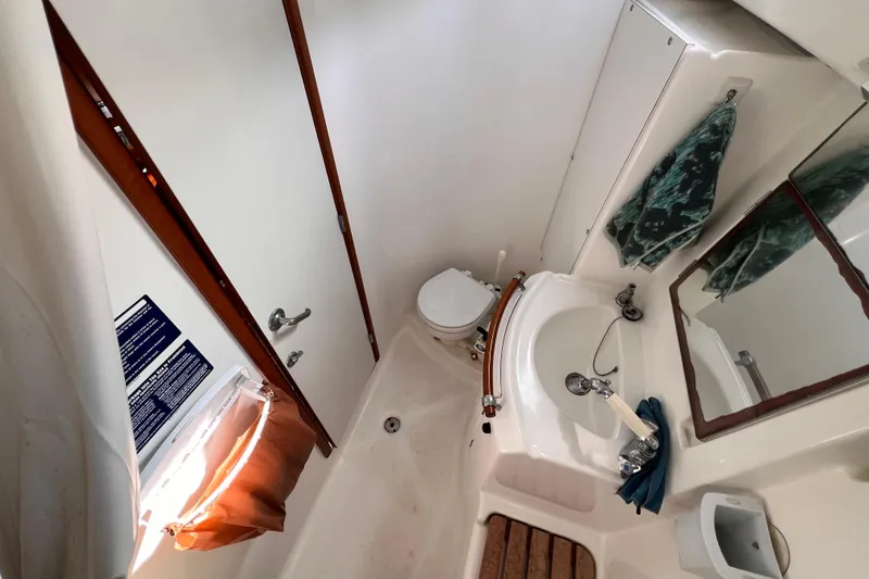Slide: The Image of Bathroom interior of 2005 Beneteau 343 sailboat with sink, toilet, and mirror. - 10