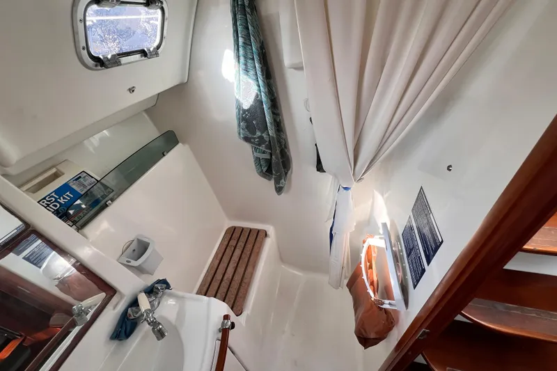Slide: The Image of 2005 Beneteau 343 yacht bathroom with sink, shower, and porthole window. - 11