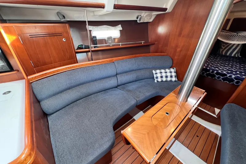 Slide: The Image of Interior of 2005 Beneteau 343 sailboat with wooden finish and blue seating. - 17