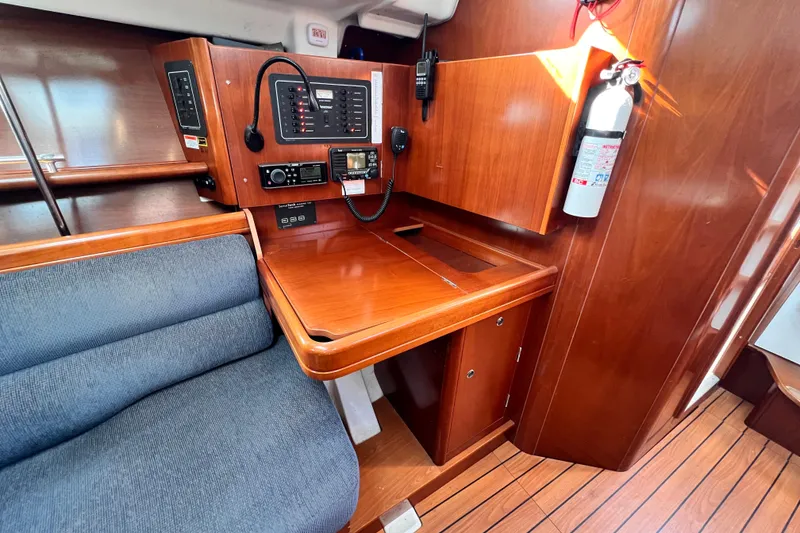 Slide: The Image of 2005 Beneteau 343 yacht interior with navigation station and wooden cabinetry. - 21