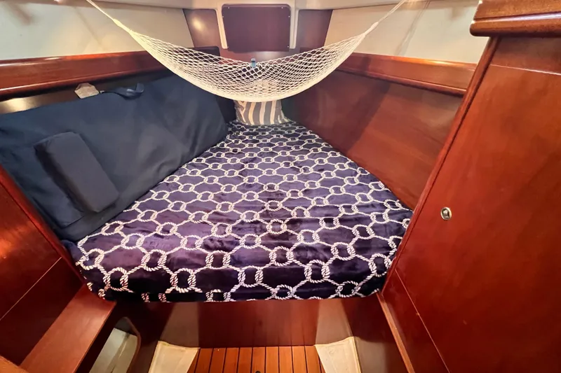 Slide: The Image of Cozy cabin interior of 2005 Beneteau 343 sailboat with nautical bedding and hammock. - 29
