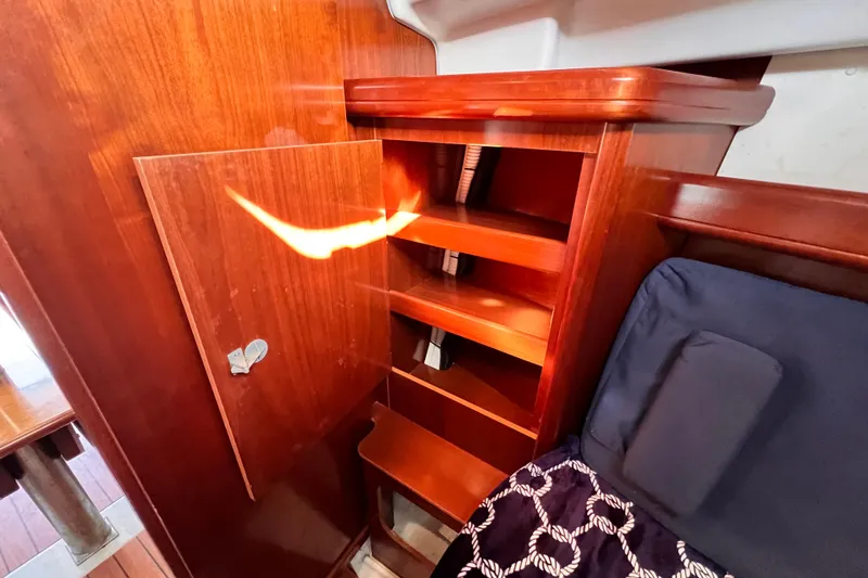 Slide: The Image of Interior of 2005 Beneteau 343 sailboat with wooden shelves and seating area. - 31