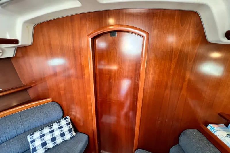 Slide: The Image of Interior of a 2005 Beneteau 343 sailboat with wooden paneling and seating. - 34