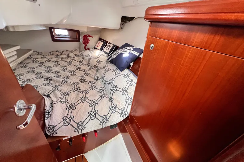 Slide: The Image of Cozy cabin interior of 2005 Beneteau 343 sailboat with nautical-themed bedding. - 37