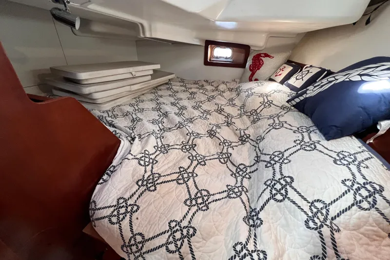 Slide: The Image of Cozy cabin interior of 2005 Beneteau 343 sailboat with nautical-themed bedding. - 38