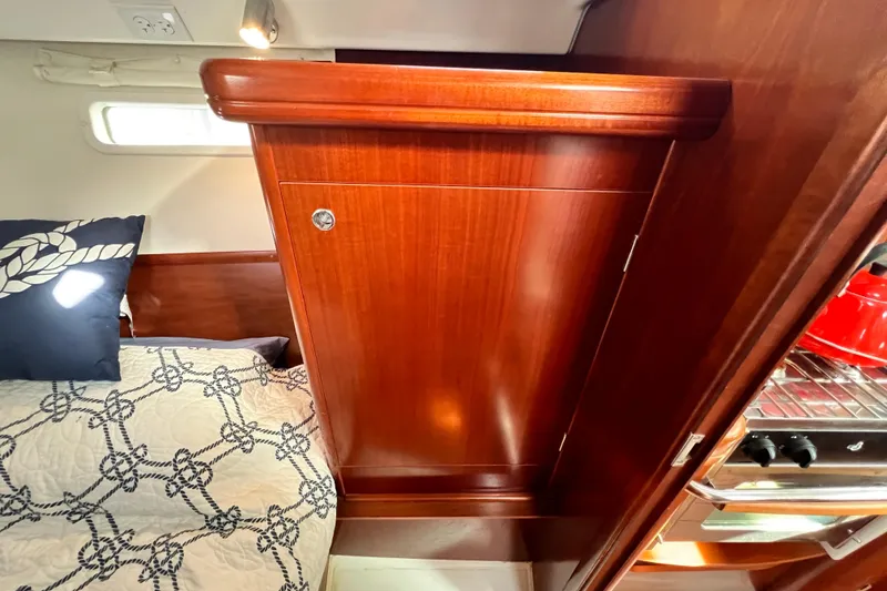Slide: The Image of Interior of 2005 Beneteau 343 yacht with wood cabinetry and nautical bedding. - 40