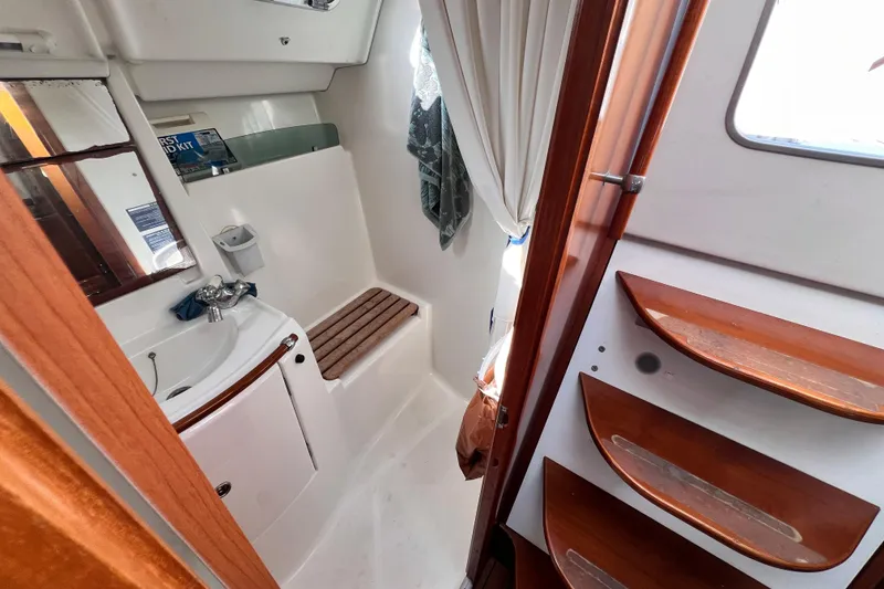 Slide: The Image of Interior of 2005 Beneteau 343 sailboat bathroom with sink, mirror, and wooden accents. - 41