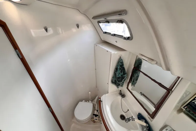 Slide: The Image of Bathroom interior of 2005 Beneteau 343 sailboat with sink, toilet, and window. - 42