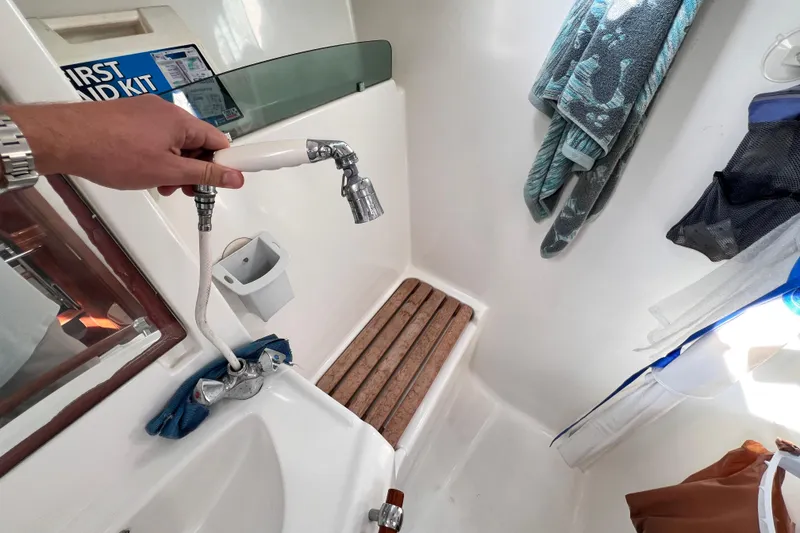 Slide: The Image of Interior of 2005 Beneteau 343 sailboat shower with handheld faucet and wooden floor slats. - 43