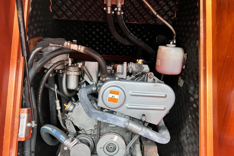 Slide: The Image of Engine compartment of a 2005 Beneteau 343 sailboat, showcasing mechanical components and hoses. - 45
