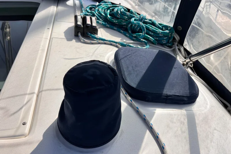 Slide: The Image of Deck of 2005 Beneteau 343 sailboat with ropes and winch cover. - 49