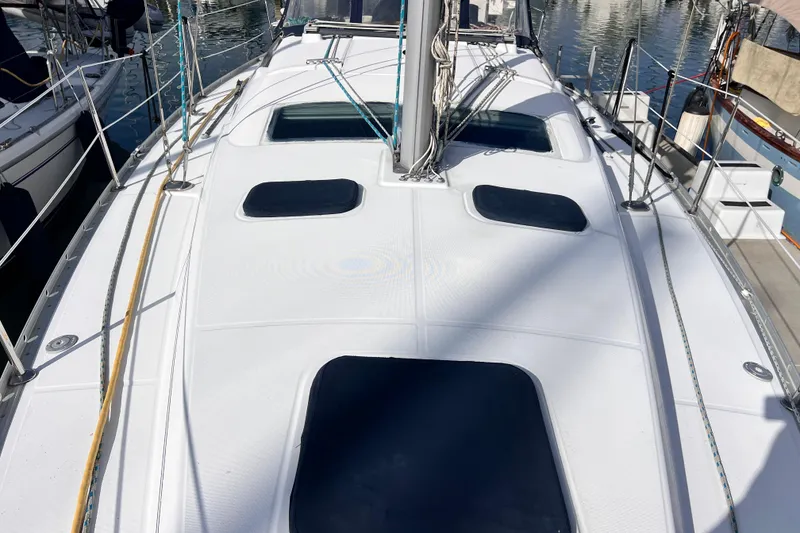 Slide: The Image of 2005 Beneteau 343 sailboat deck with hatches and rigging in marina. - 55