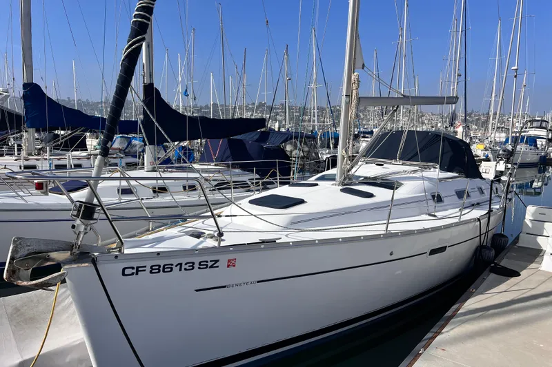 Slide: The Image of 2005 Beneteau 343 sailboat docked in a marina, surrounded by other boats. - 56