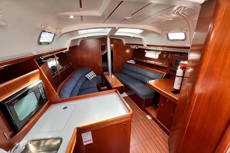 Slide: The Image of Interior of 2005 Beneteau 343 sailboat with wood finish, seating, and kitchenette. - 6