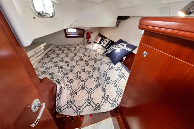 Slide: The Image of Cozy cabin interior of 2005 Beneteau 343 sailboat with nautical-themed bedding. - 9