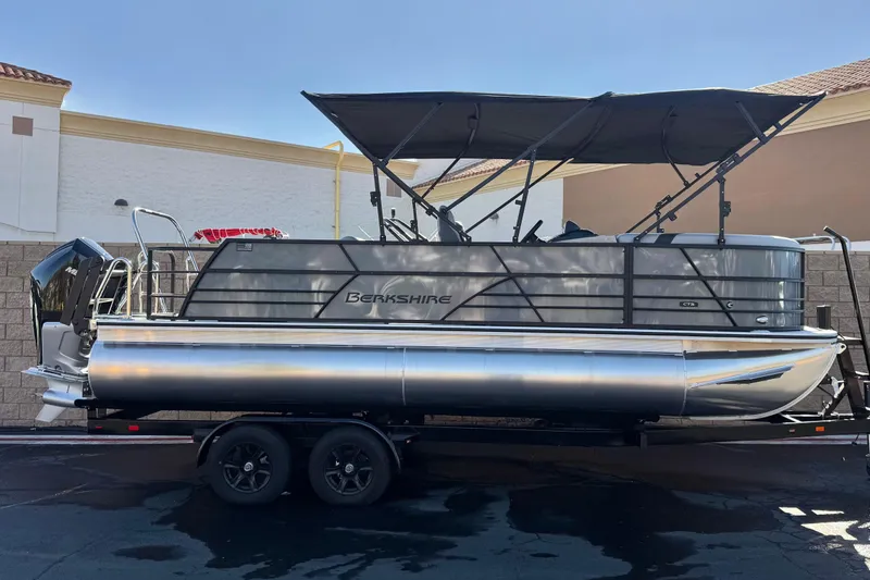 The Image of 2026 Berkshire 22UL CTS pontoon boat on trailer, featuring sleek design and canopy. - 0
