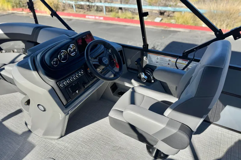 Slide: The Image of 2026 Berkshire 22UL CTS boat interior with steering wheel and captain's chair. - 25