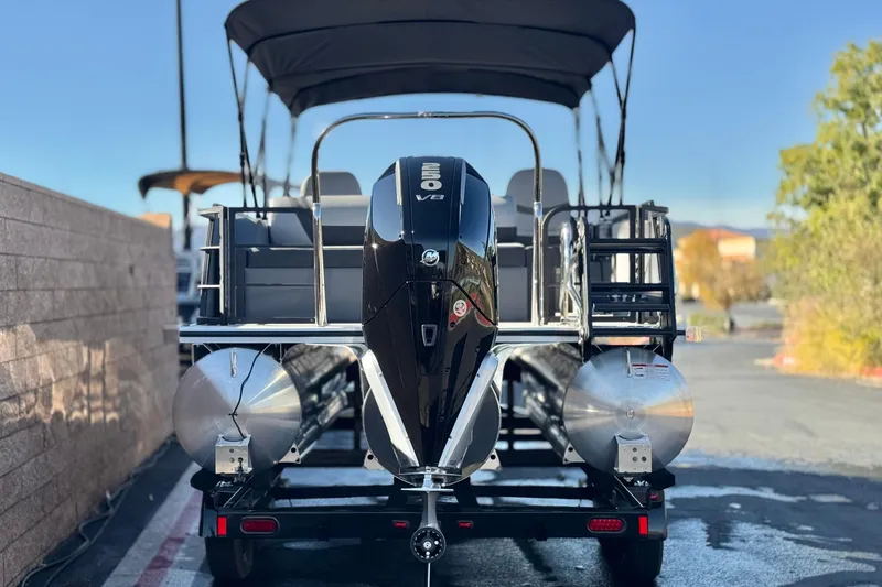 Slide: The Image of 2026 Berkshire 22UL CTS pontoon boat with powerful engine, parked outdoors. - 5