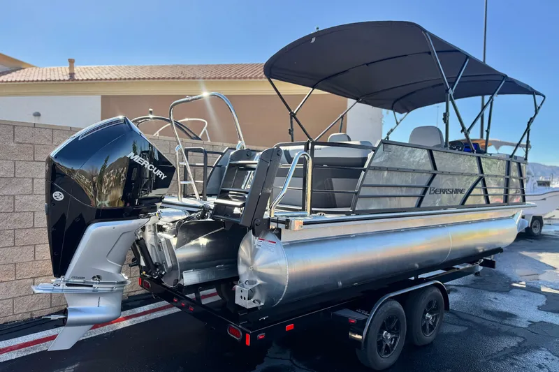 Slide: The Image of 2026 Berkshire 22UL CTS pontoon boat with Mercury outboard engine on trailer. - 6
