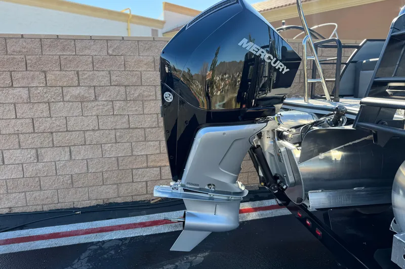 Slide: The Image of Outboard motor on 2026 Berkshire 22UL CTS pontoon boat, parked near brick wall. - 7