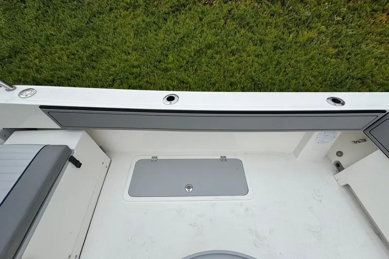 Slide: The Image of 2026 Defiance Admiral 220 EX boat interior with seating and storage compartments. - 16