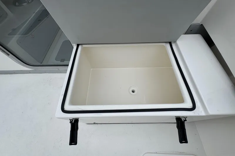 Slide: The Image of Open storage compartment on 2026 Defiance Admiral 220 EX boat. - 24