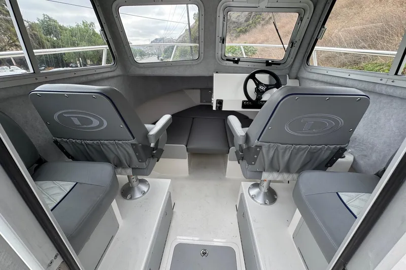 Slide: The Image of Interior of 2026 Defiance Admiral 220 EX boat with seating and steering wheel. - 28
