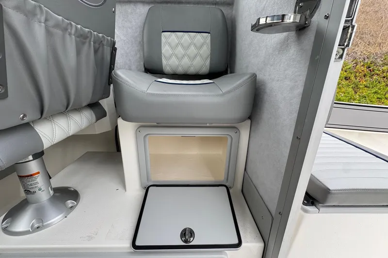 Slide: The Image of Interior of 2026 Defiance Admiral 220 EX boat with gray seating and storage compartment. - 31