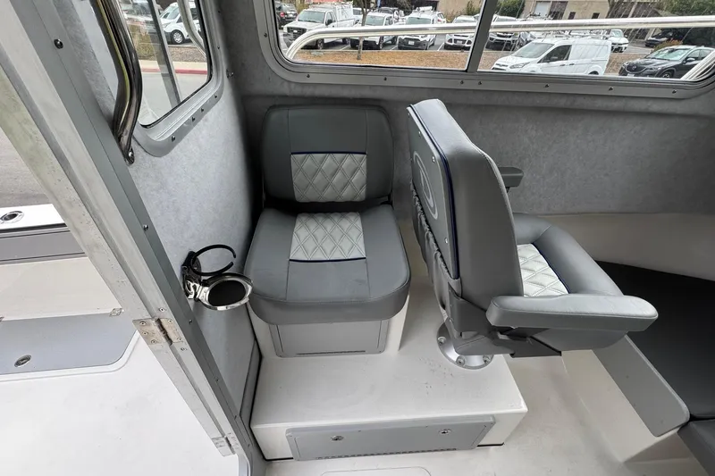 Slide: The Image of Interior seating of 2026 Defiance Admiral 220 EX boat, featuring gray cushioned seats. - 36