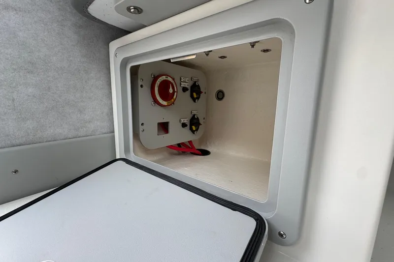 Slide: The Image of Electrical compartment of 2026 Defiance Admiral 220 EX boat, featuring control switches. - 38