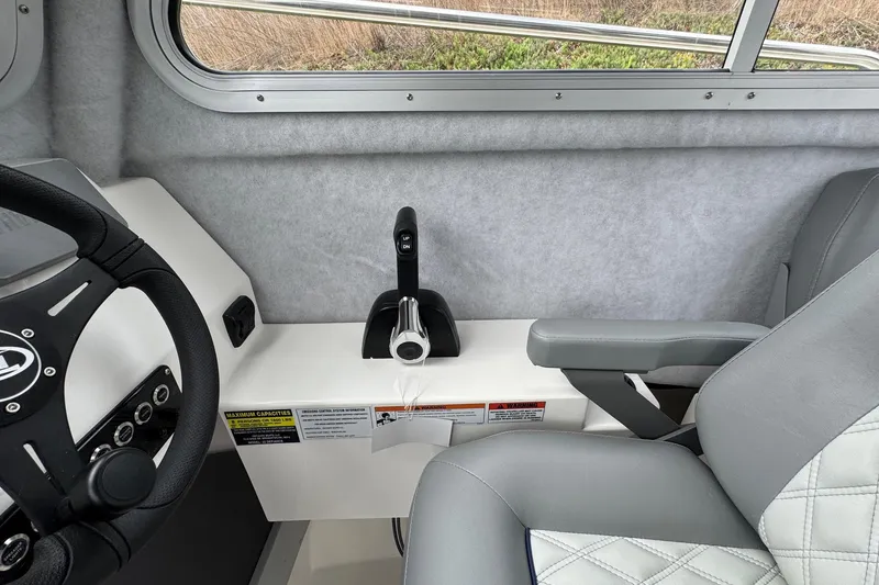 Slide: The Image of Interior of 2026 Defiance Admiral 220 EX boat, featuring steering wheel and throttle controls. - 43