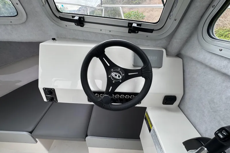 Slide: The Image of Interior of 2026 Defiance Admiral 220 EX boat, featuring steering wheel and control panel. - 45