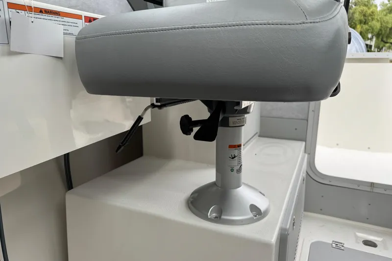 Slide: The Image of 2026 Defiance Admiral 220 EX boat seat with adjustable pedestal and safety warnings. - 56