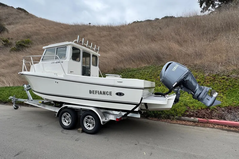 Slide: The Image of 2026 Defiance Admiral 220 EX boat on trailer with Yamaha outboard motor. - 6