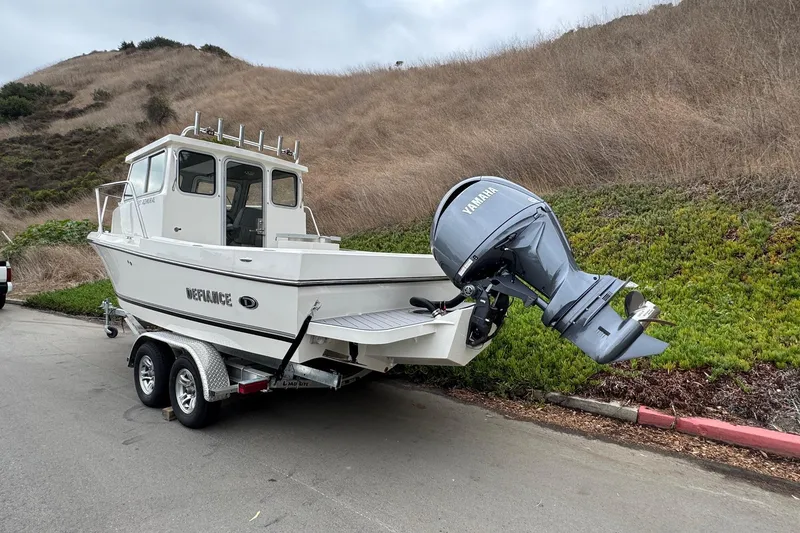 Slide: The Image of 2026 Defiance Admiral 220 EX boat on trailer with Yamaha outboard motor. - 7